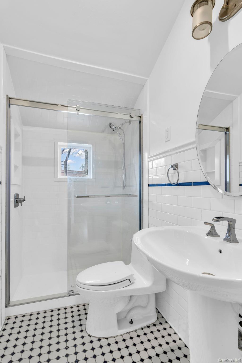 475 Dobbs Ferry Road White Plains, NY 10607 - Photo 25 of 29 a bathroom with a sink a toilet and shower