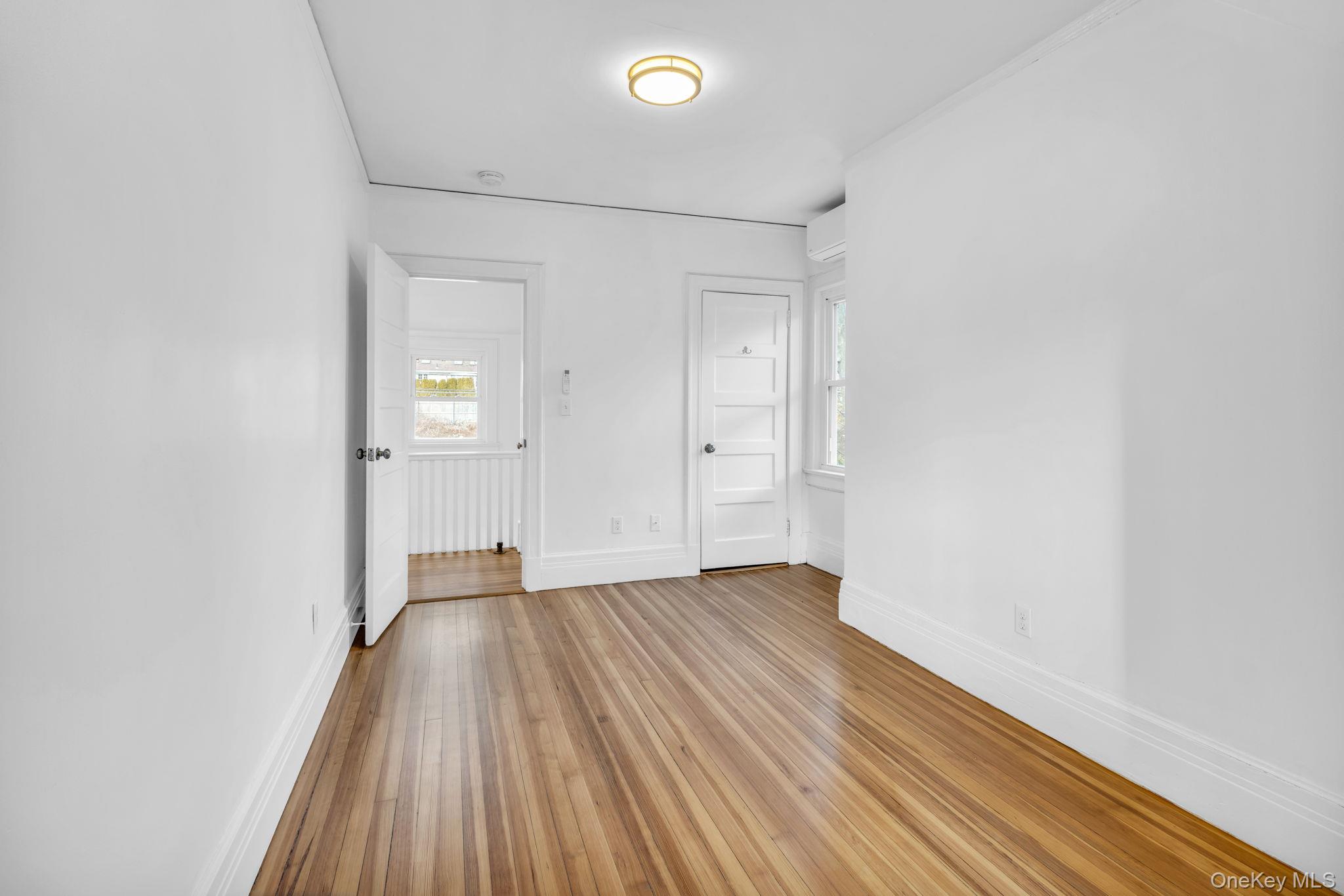 475 Dobbs Ferry Road White Plains, NY 10607 - Photo 28 of 29 wooden floor in an empty room with a window
