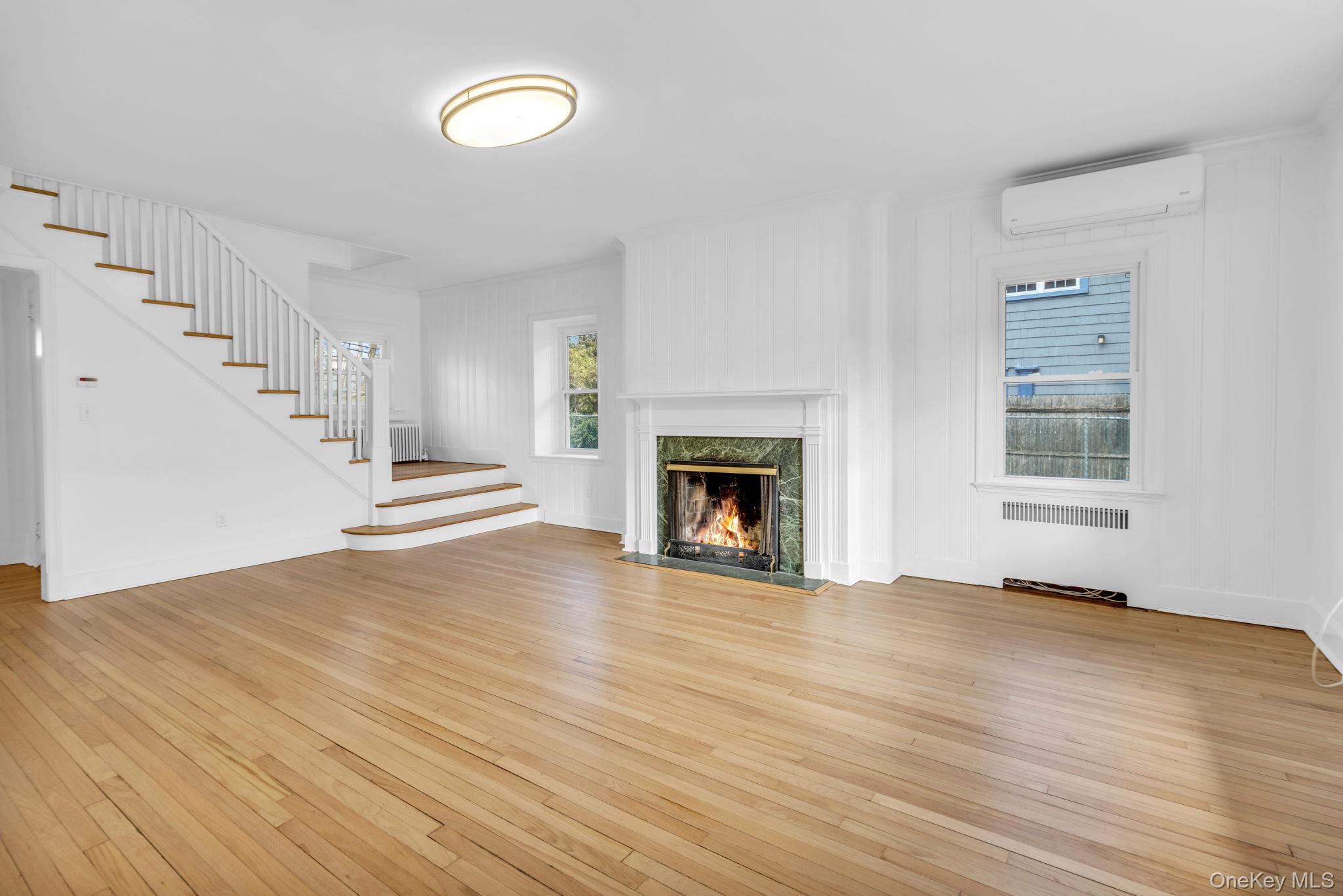 475 Dobbs Ferry Road White Plains, NY 10607 - Photo 4 of 29 a view of empty room with wooden floor and fireplace