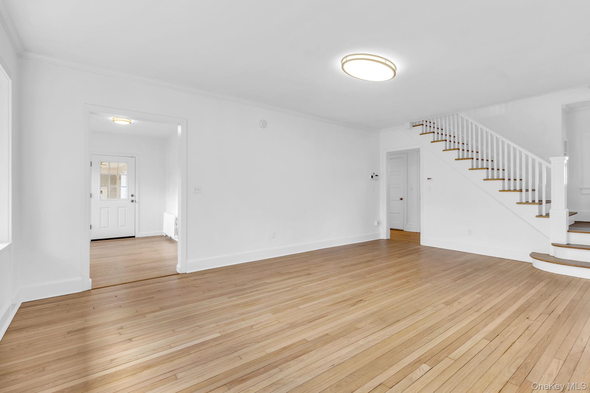 475 Dobbs Ferry Road White Plains, NY 10607 - Photo 5 of 29 a view of an empty room with wooden floor and stairs