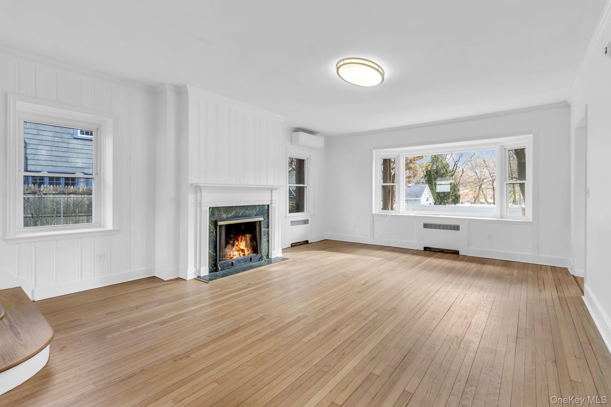 475 Dobbs Ferry Road White Plains, NY 10607 - Photo 7 of 29 a view of empty room with wooden floor and fireplace