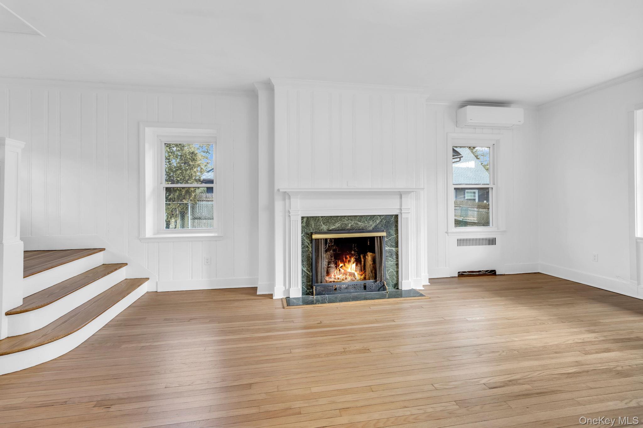 475 Dobbs Ferry Road White Plains, NY 10607 - Photo 8 of 29 wooden floor fireplace and windows in an empty room