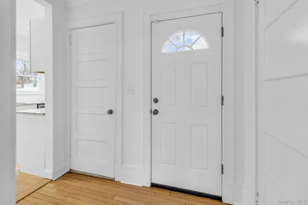 a view of empty room with wooden floor