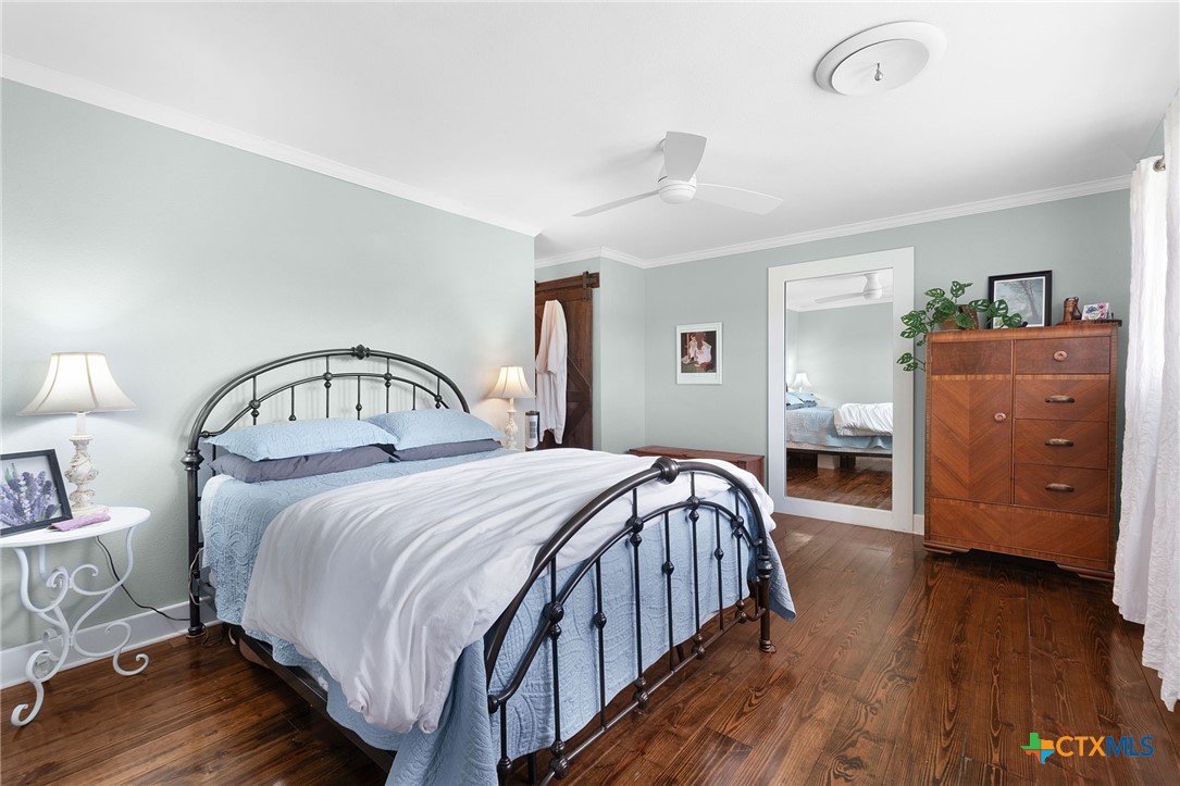 951 Moseley Road Copperas Cove, TX 76522 - Photo 20 of 43 a bedroom with a bed and wooden floor