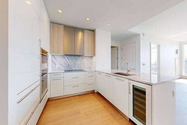 a kitchen with granite countertop stainless steel appliances sink and cabinets