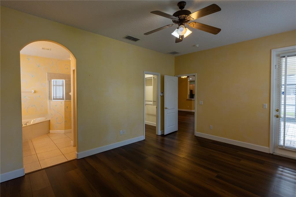 65 Calliope Street Ocoee, FL 34761 - Photo 16 of 60 a view of a room with wooden floor and a ceiling fan
