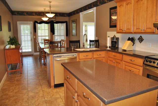 377 Wheeler Road Gray, GA 31032 - Photo 3 of 45 a kitchen with stainless steel appliances granite countertop a sink a stove and a refrigerator