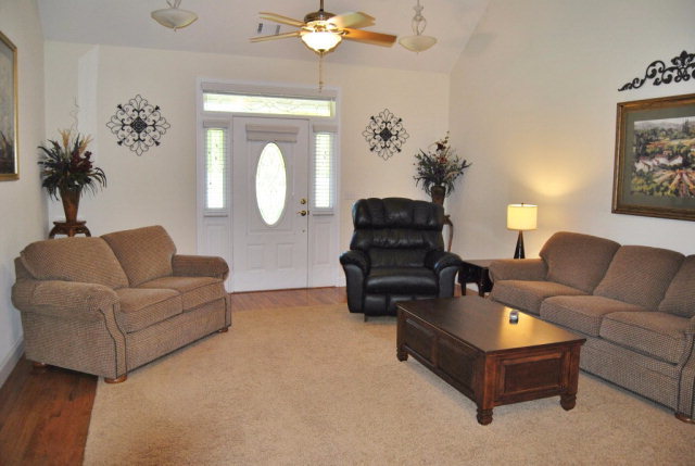 377 Wheeler Road Gray, GA 31032 - Photo 22 of 45 a living room with furniture and a chandelier