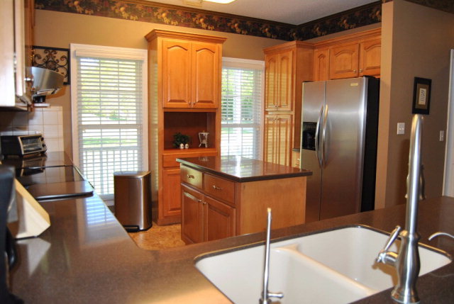 377 Wheeler Road Gray, GA 31032 - Photo 23 of 45 a kitchen with granite countertop a sink stainless steel appliances and furniture