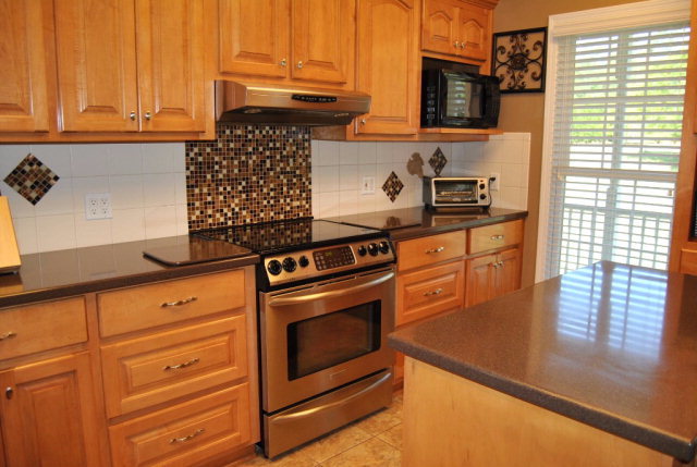 377 Wheeler Road Gray, GA 31032 - Photo 24 of 45 a kitchen with granite countertop cabinets stainless steel appliances and a window