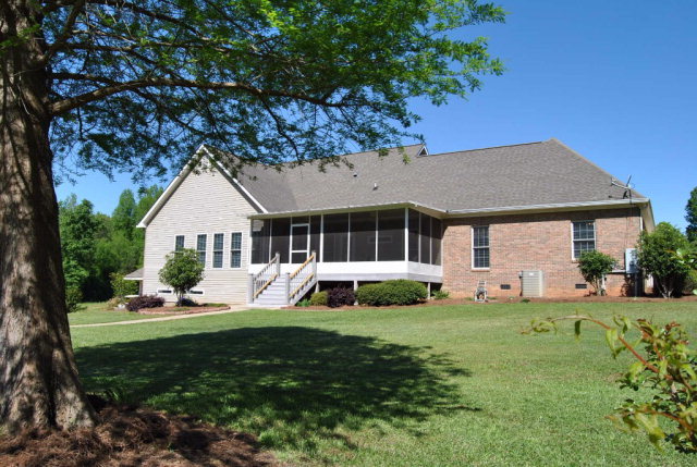 377 Wheeler Road Gray, GA 31032 - Photo 38 of 45 a front view of a house with a garden and trees