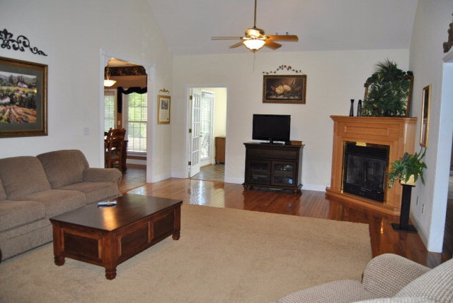 377 Wheeler Road Gray, GA 31032 - Photo 5 of 45 a living room with furniture a flat screen tv and a fireplace