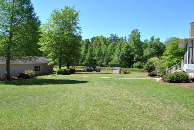 377 Wheeler Road Gray, GA 31032 - Photo 43 of 45 a white house with a big yard and large trees