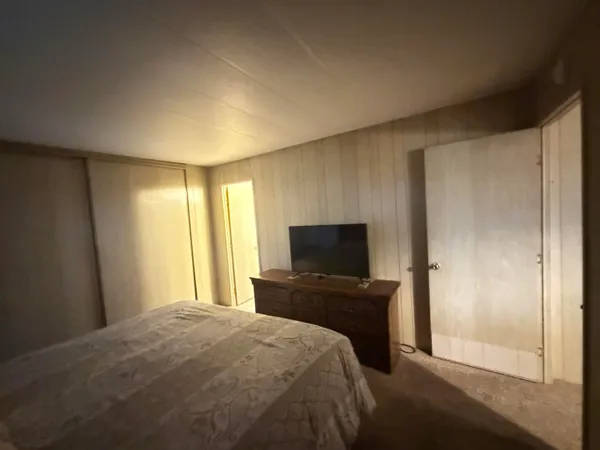 a spacious bathroom with a tub sink and mirror