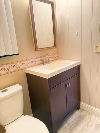 a bed sitting in a spacious bedroom next to a window