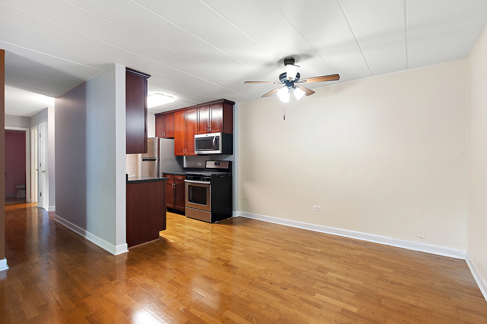 1000 South Lorraine Road, Unit 110 Wheaton, IL 60189 - Photo 13 of 29 a view of a kitchen with a stove cabinets and wooden floor