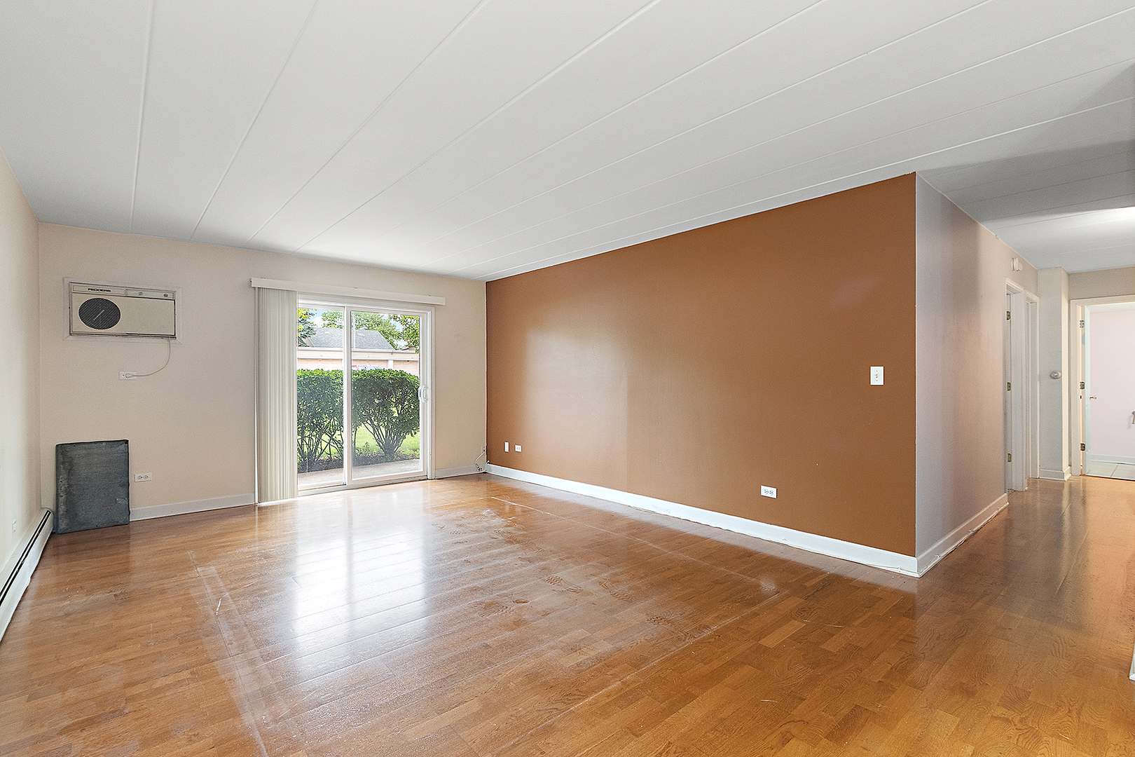 1000 South Lorraine Road, Unit 110 Wheaton, IL 60189 - Photo 14 of 29 an empty room with wooden floor and windows