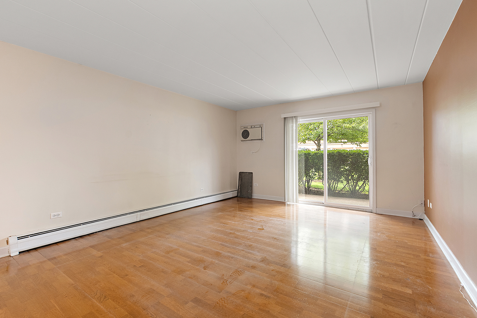 1000 South Lorraine Road, Unit 110 Wheaton, IL 60189 - Photo 15 of 29 an empty room with wooden floor and windows