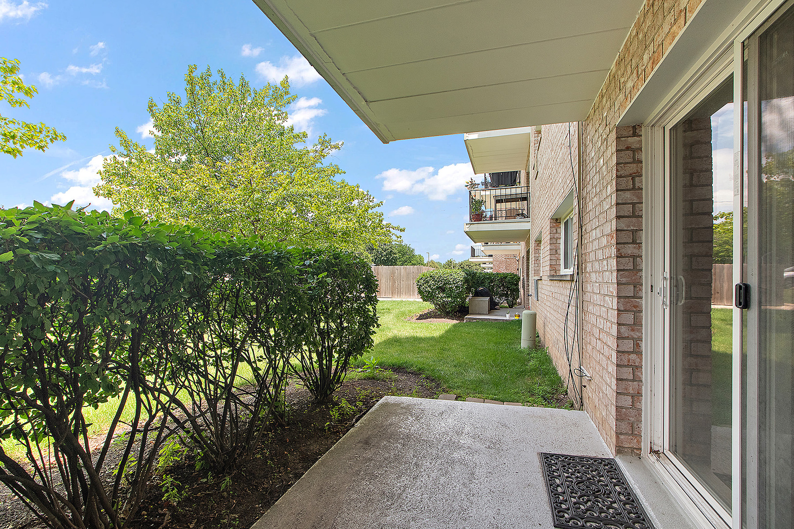 1000 South Lorraine Road, Unit 110 Wheaton, IL 60189 - Photo 25 of 29 a view of a back yard from a corridor