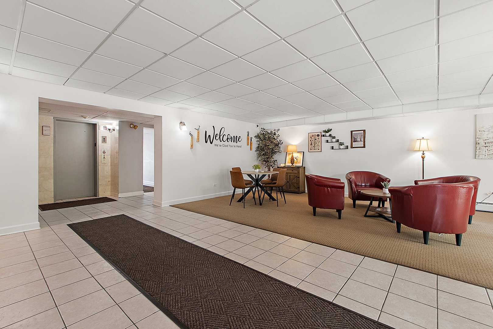 1000 South Lorraine Road, Unit 110 Wheaton, IL 60189 - Photo 3 of 29 a living room with furniture and a lamp