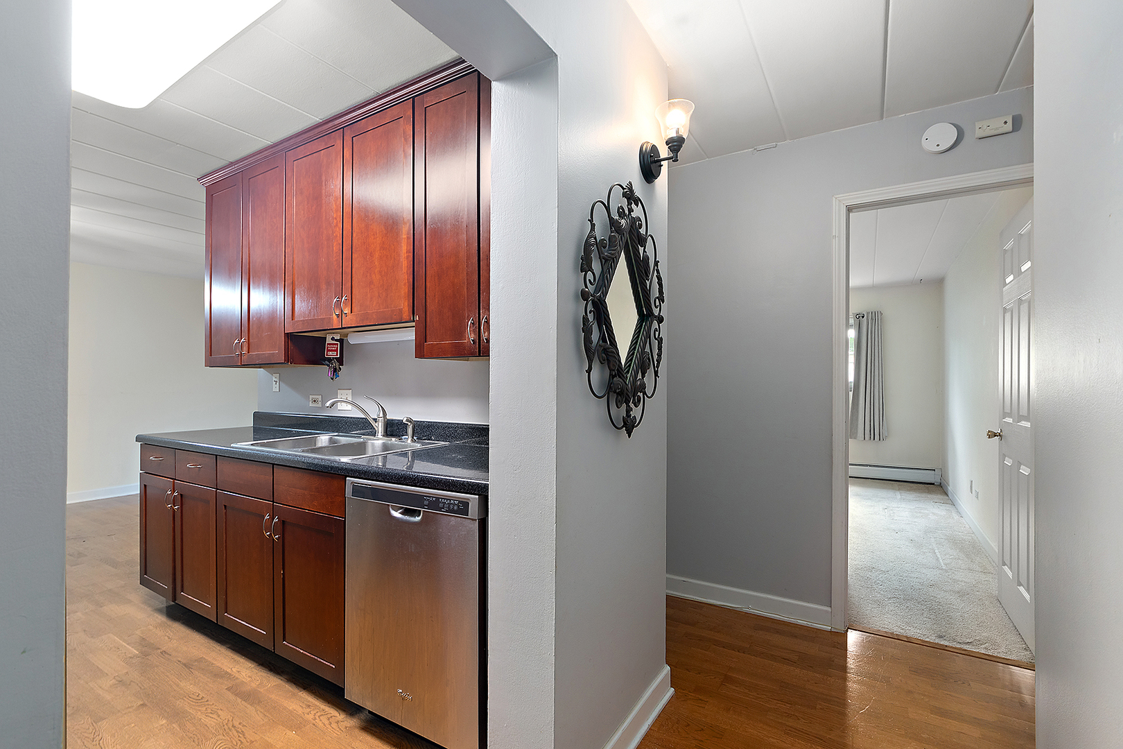 1000 South Lorraine Road, Unit 110 Wheaton, IL 60189 - Photo 8 of 29 a kitchen with stainless steel appliances granite countertop cabinets and refrigerator