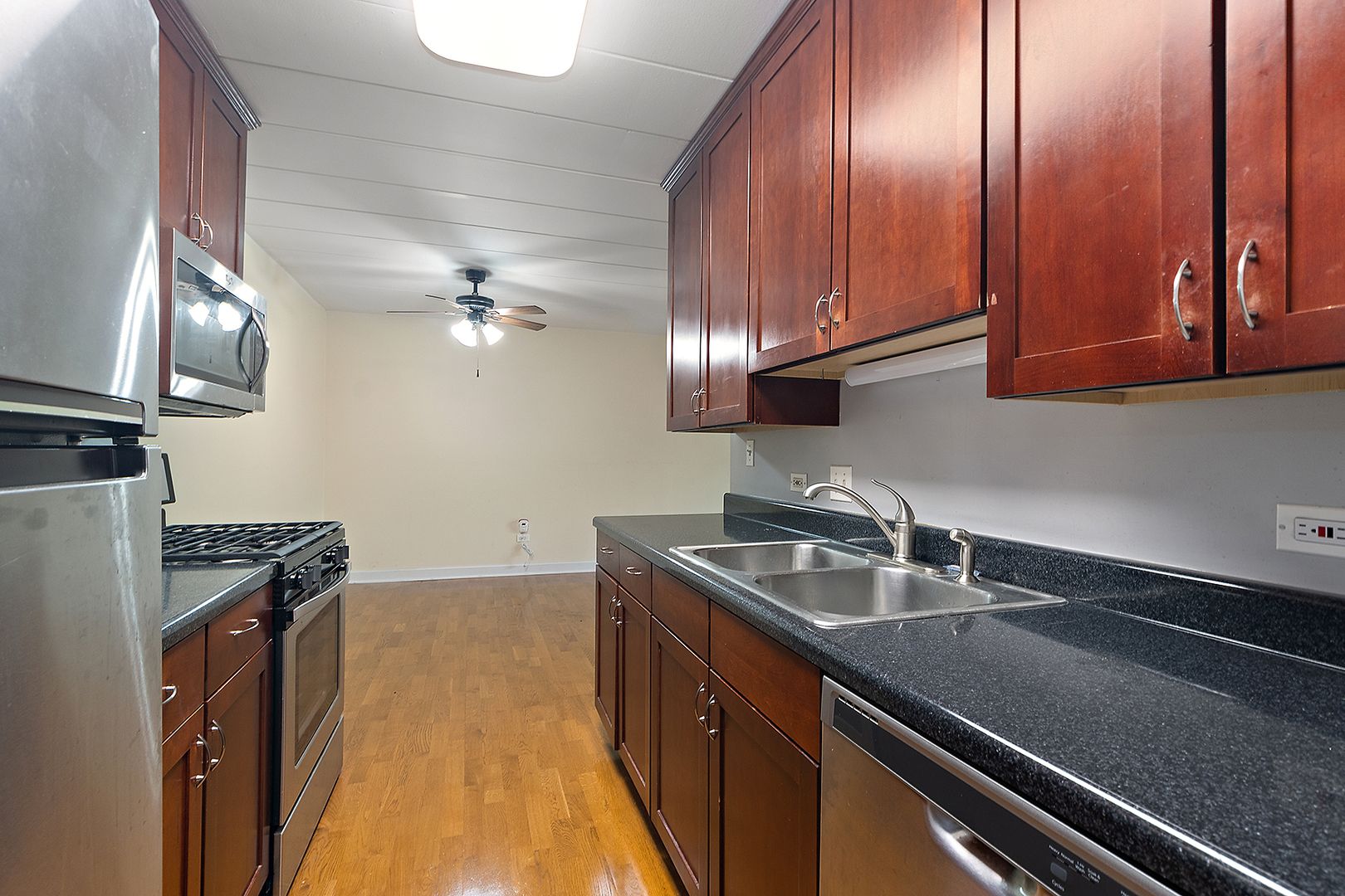 1000 South Lorraine Road, Unit 110 Wheaton, IL 60189 - Photo 10 of 29 a kitchen with granite countertop stainless steel appliances a sink stove and cabinets