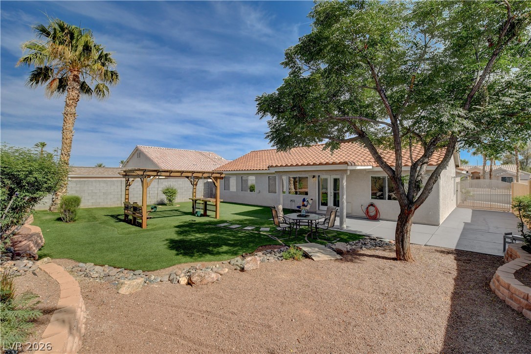 910 Cobblestone Cove Road North Las Vegas, NV 89081 - Photo 25 of 30 A spacious backyard retreat features artificial turf, a charming gazebo, and an outdoor dining area.
