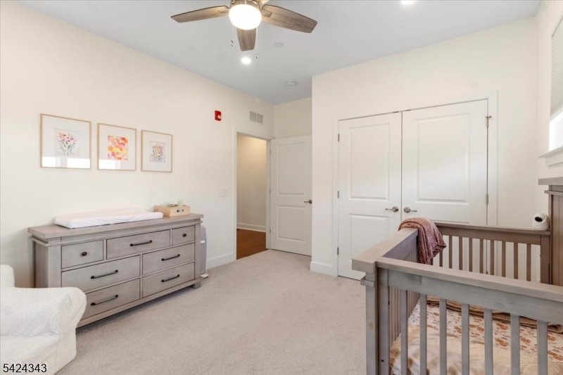 11 Veterans Way, Unit 111 Morris Plains, NJ 07950 - Photo 14 of 21 a bedroom with furniture and baby crib