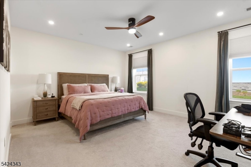 11 Veterans Way, Unit 111 Morris Plains, NJ 07950 - Photo 16 of 21 a bedroom with bed and chair