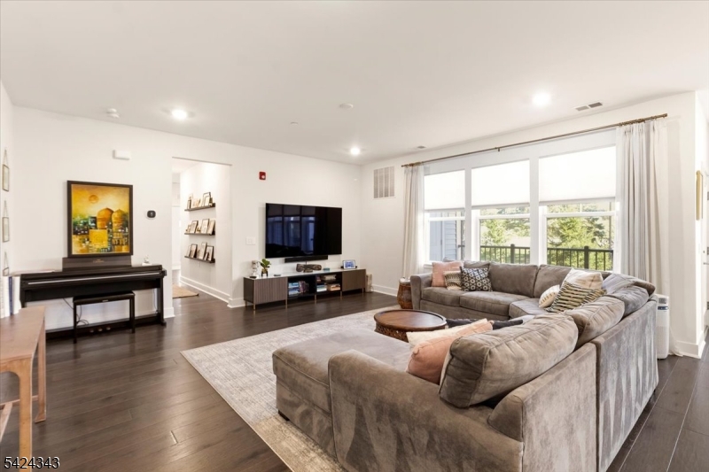 11 Veterans Way, Unit 111 Morris Plains, NJ 07950 - Photo 6 of 21 a living room with furniture and a flat screen tv