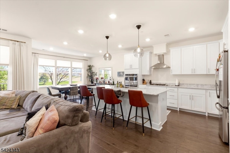 11 Veterans Way, Unit 111 Morris Plains, NJ 07950 - Photo 7 of 21 a living room with kitchen island furniture and a large window