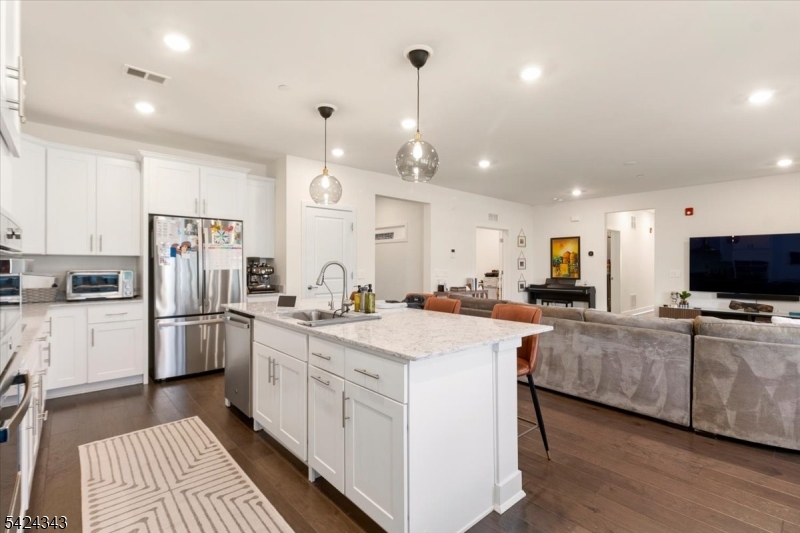 11 Veterans Way, Unit 111 Morris Plains, NJ 07950 - Photo 8 of 21 a kitchen with stainless steel appliances a stove refrigerator sink and microwave