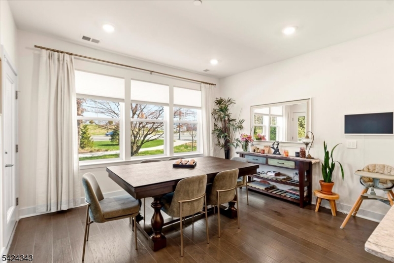 11 Veterans Way, Unit 111 Morris Plains, NJ 07950 - Photo 9 of 21 a view of a dining room with furniture window and wooden floor
