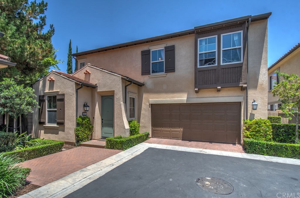 83 Splendor Irvine, CA 92618 - Photo 1 of 1 a front view of a house with a yard and garage