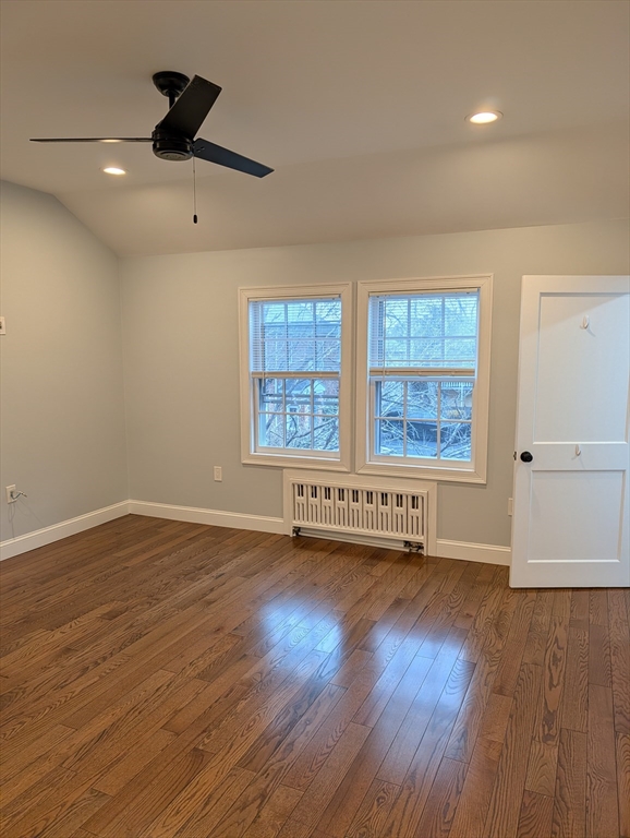 260 Main Street, Unit 12 Medford, MA 02155 - Photo 3 of 10 an empty room with wooden floor and windows