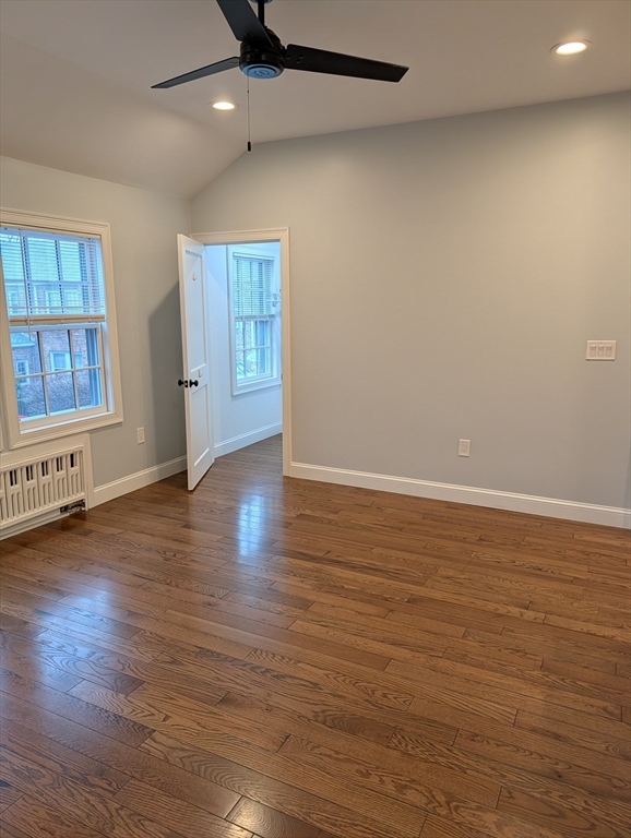 260 Main Street, Unit 12 Medford, MA 02155 - Photo 4 of 10 an empty room with wooden floor and windows