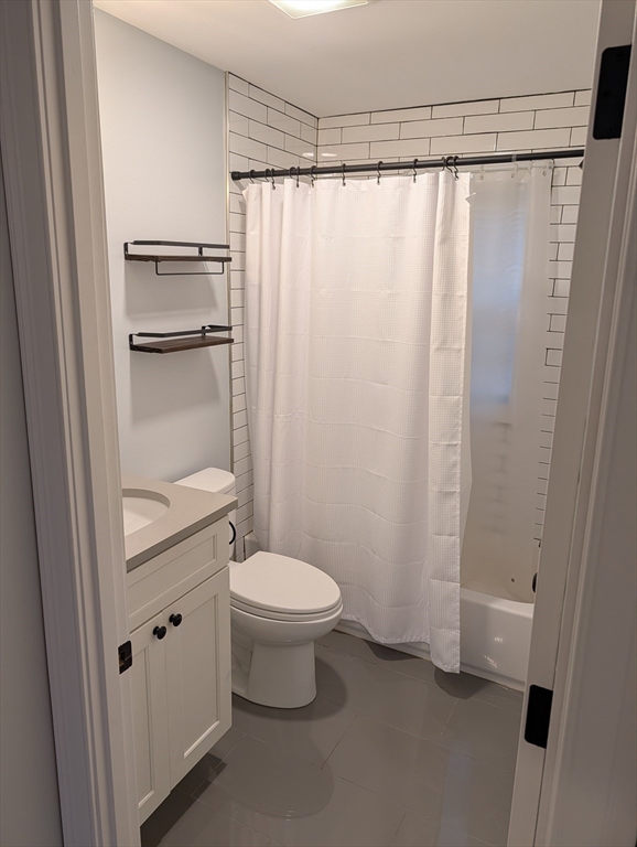 260 Main Street, Unit 12 Medford, MA 02155 - Photo 6 of 10 a bathroom with a granite countertop sink toilet and shower