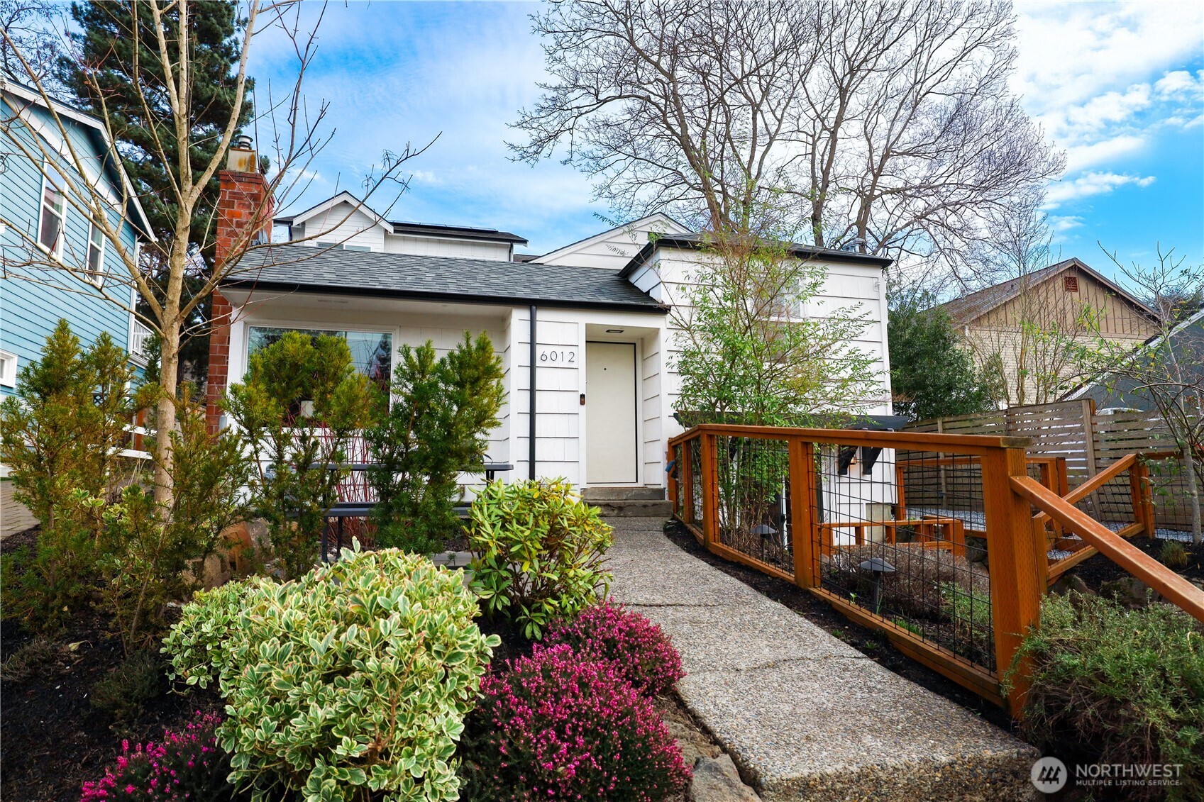 6012 40th Avenue Northeast Seattle, WA 98115 - Photo 1 of 28 a view of a house with wooden floor fence and a potted plant