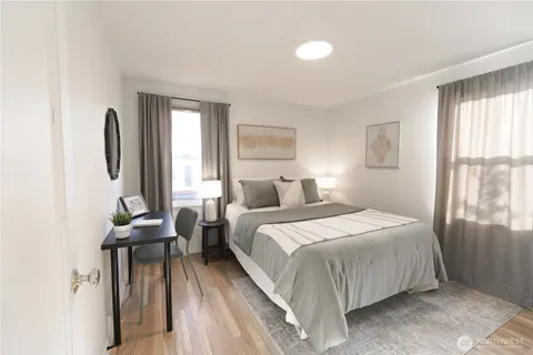 a bedroom with a bed and windows