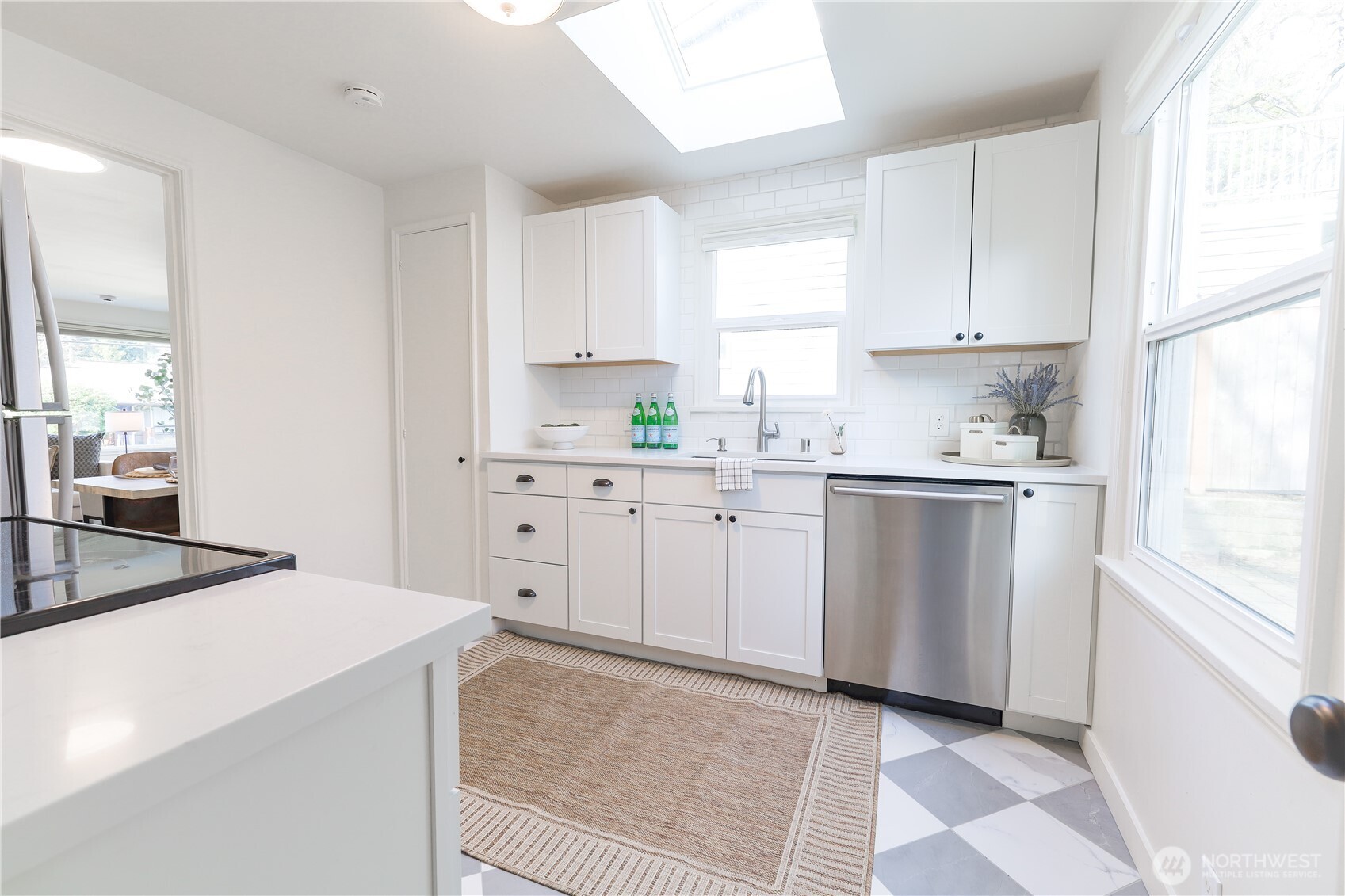6012 40th Avenue Northeast Seattle, WA 98115 - Photo 16 of 28 a kitchen with white cabinets sink and appliances