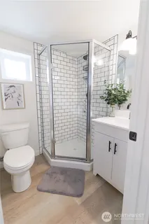 a bathroom with a toilet and a shower