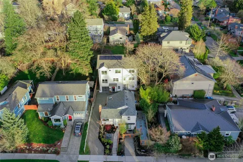 an aerial view of multiple houses with yard