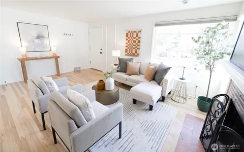a living room with furniture a rug and a window