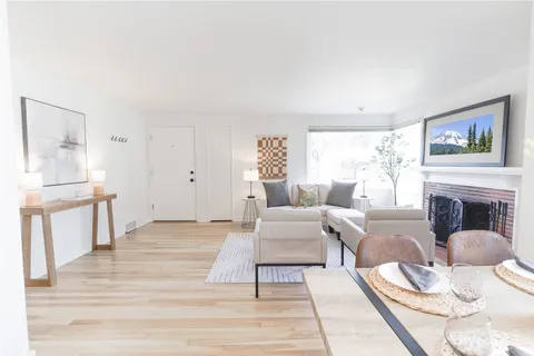 a living room with furniture a fireplace and next to a window