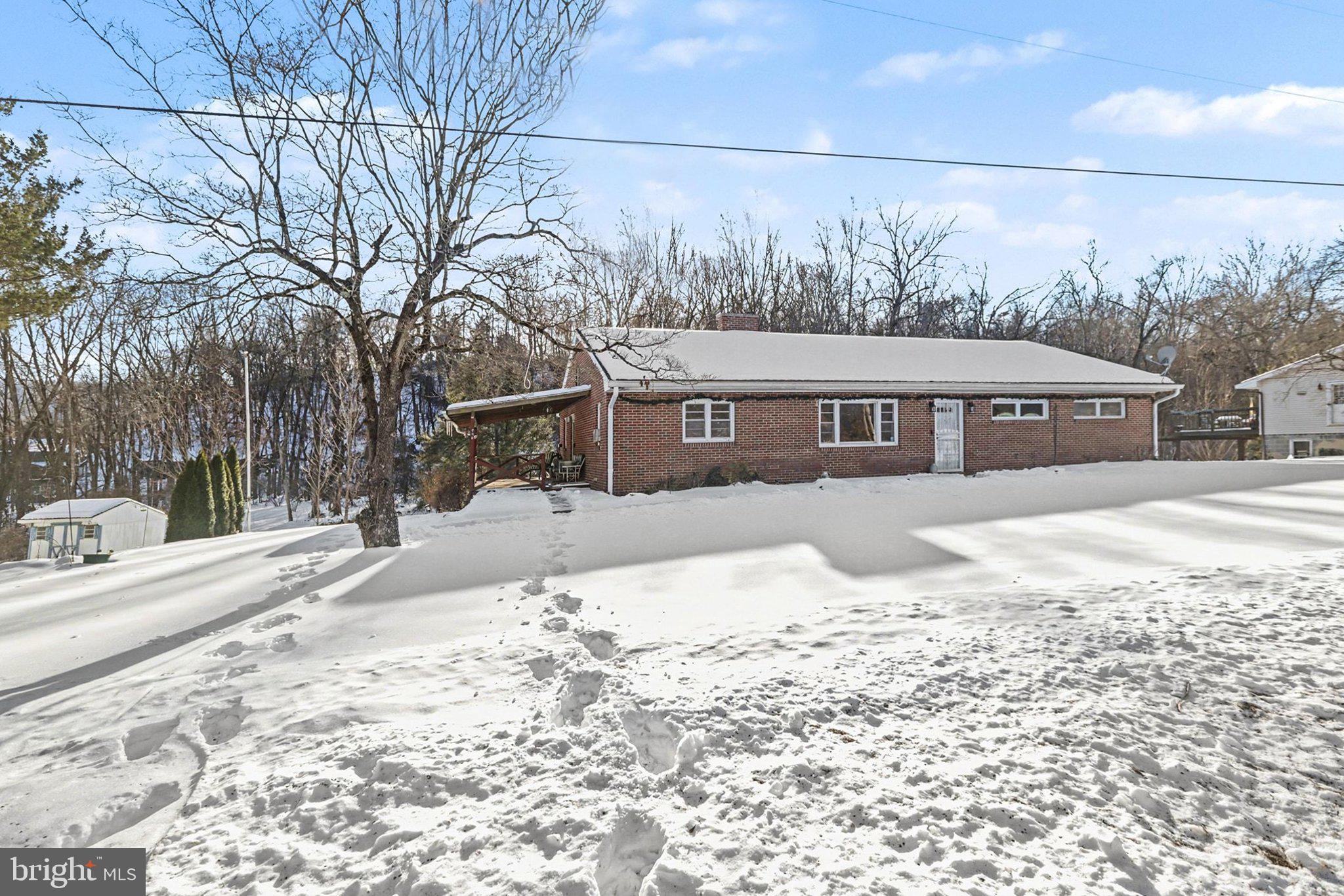 908 Red Hill Road Dauphin, PA 17018 - Photo 3 of 33 a front view of a house with a yard covered in snow