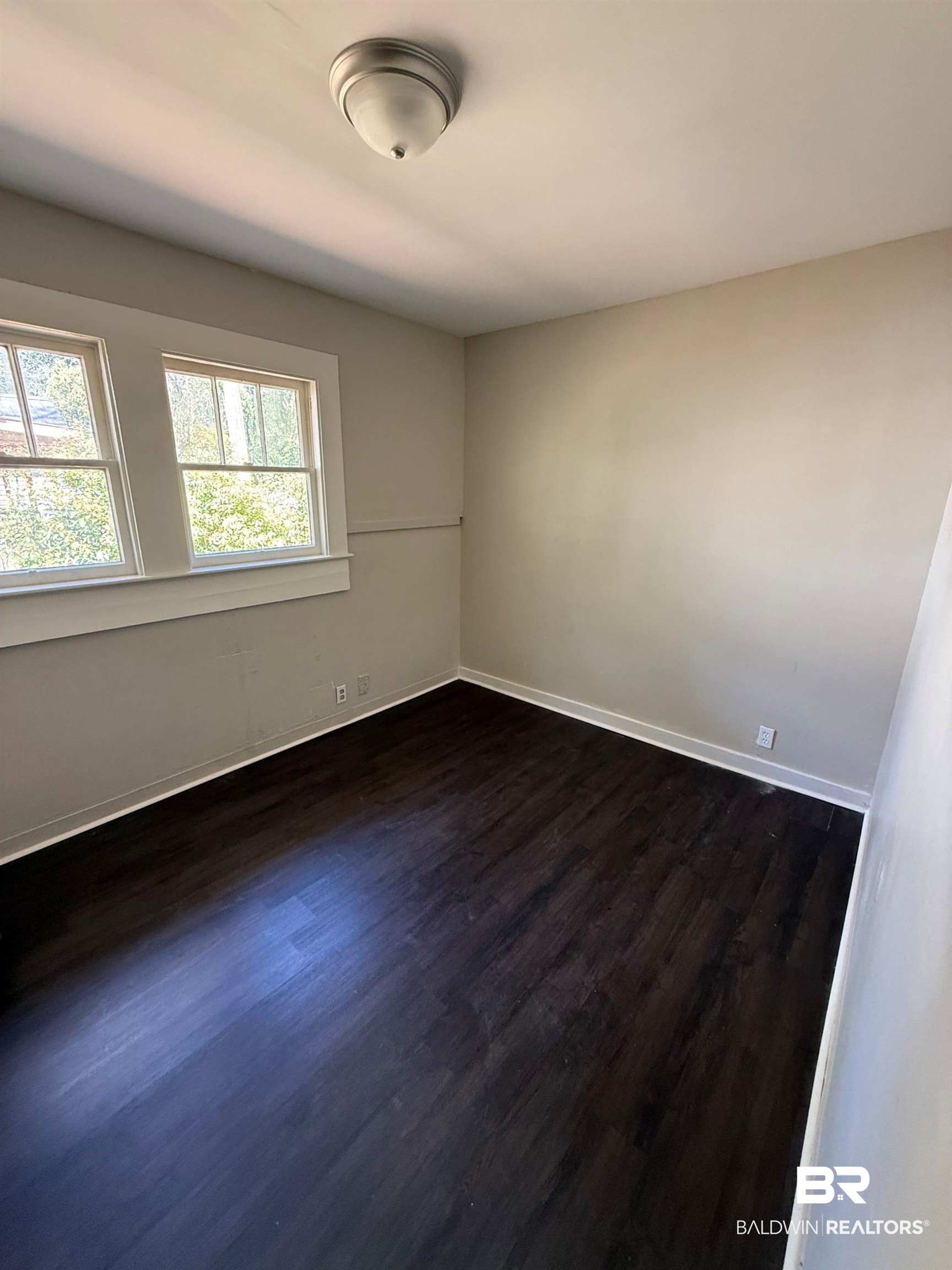 655 Mandrell Street Mobile, AL 36606 - Photo 7 of 12 Spare room with dark wood-style flooring and baseboards