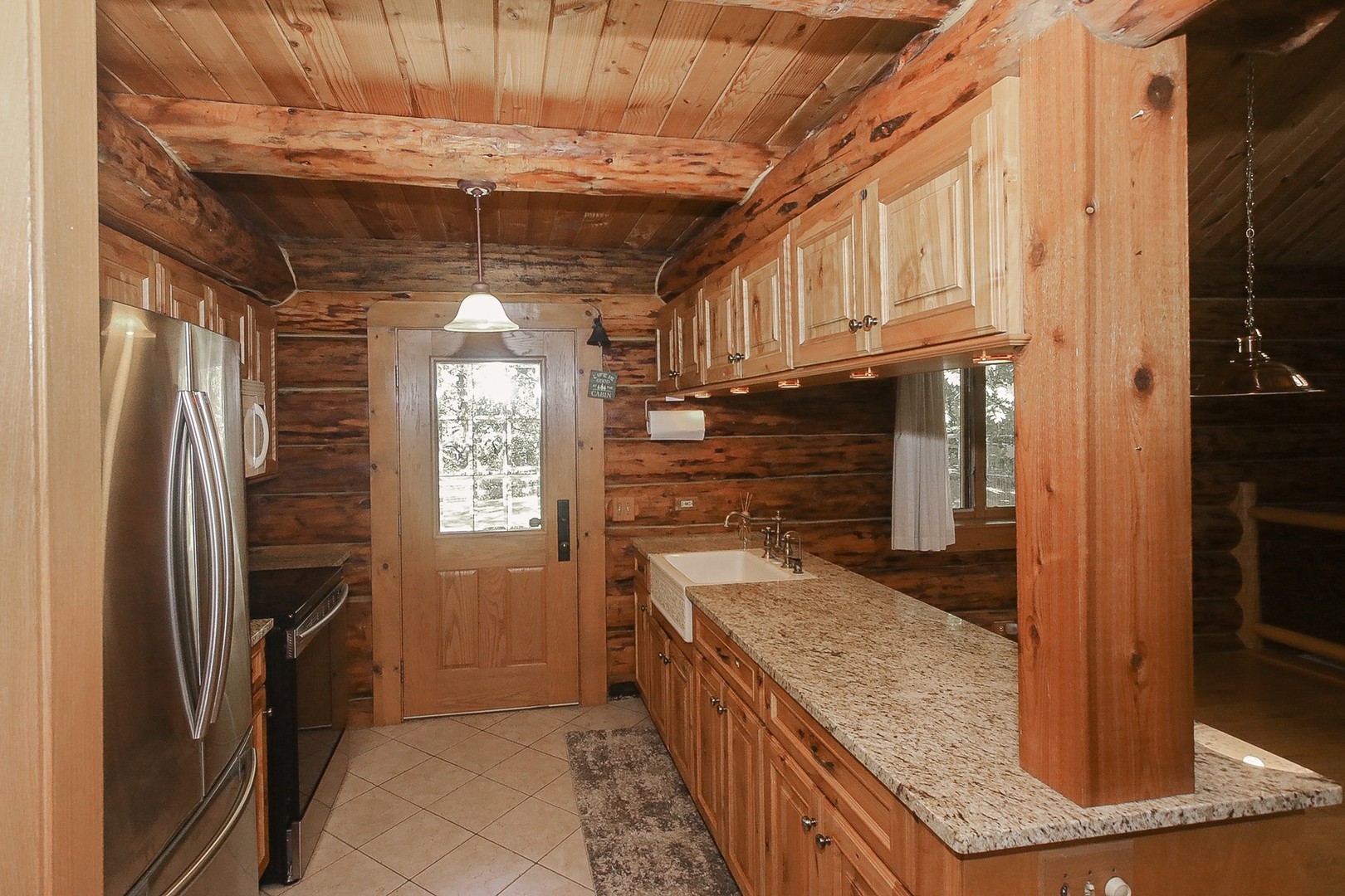 8108 Crystal Springs Road Bull Valley, IL 60098 - Photo 11 of 33 a kitchen with stainless steel appliances granite countertop a refrigerator a stove and a sink