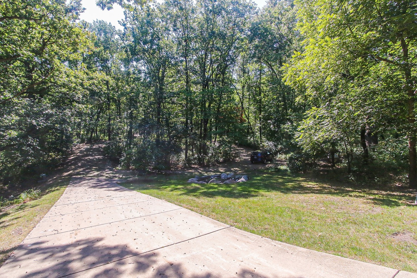 8108 Crystal Springs Road Bull Valley, IL 60098 - Photo 33 of 33 a view of a yard with plants and large trees