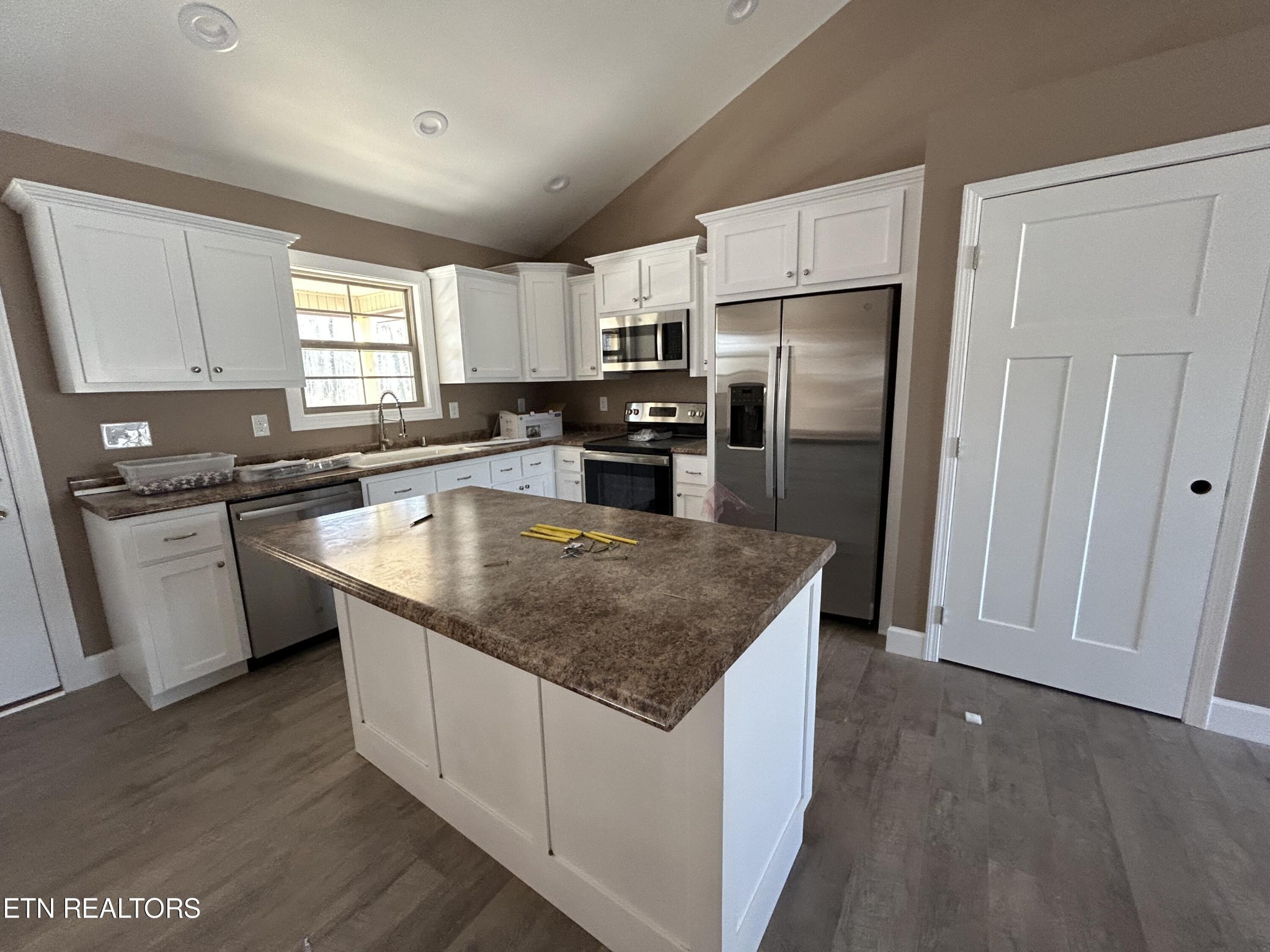 162 Jay Loop Jamestown, TN 38556 - Photo 5 of 15 a kitchen with stainless steel appliances granite countertop a sink stove microwave and refrigerator
