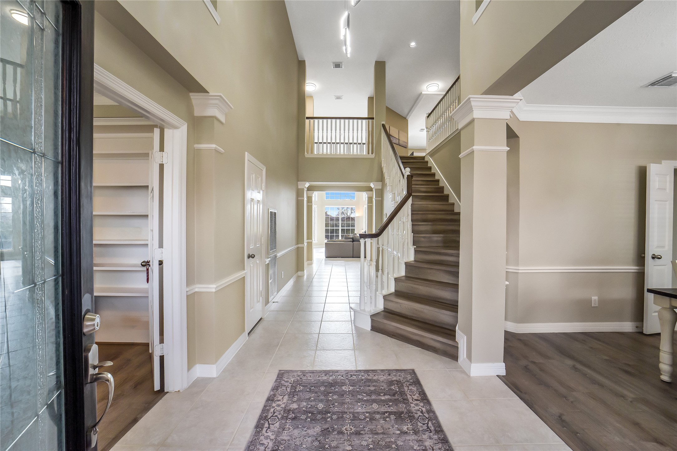 24403 Falcon Point Drive Katy, TX 77494 - Photo 4 of 32 Grand two-story foyer featuring a sweeping staircase, perfectly positioned between the dedicated study and formal dining area.